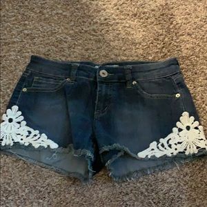 Guess jean shorts with white embroidered designs